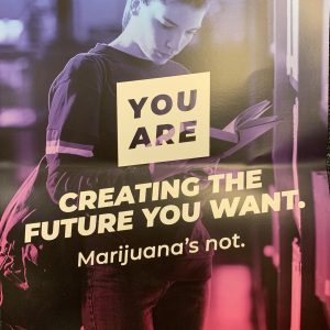 Colorful purple and blue poster showing a photo of a teen in the hallway of a school and YOU ARE creating the future you want in white text over the top