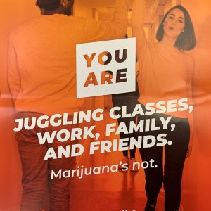 Colorful orange and red poster showing a photo of two teens high-fiving in a school hallway and the text YOU ARE juggling classes, work, family, and friends