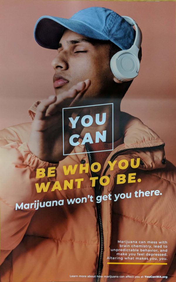 Colorful orange and blue poster with a photo of a male student with headphones on and the text YOU CAN be who you want to be