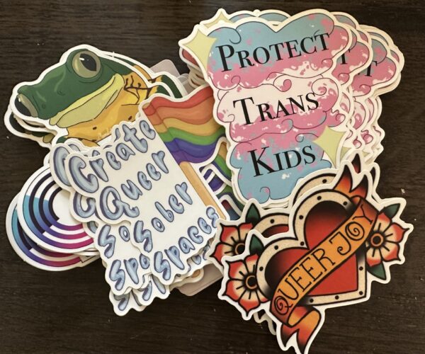 Includes a mix of stickers that feature messages like “Protect Trans Kids,” “Queer Joy,” and “Queer Sober Spaces.” Approximately 80 stickers per pack.
